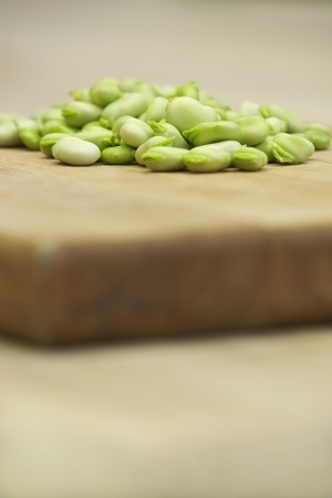 Fresh broad beans on wooden board close-upの写真素材