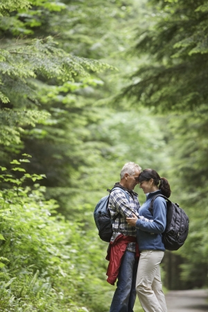 Couple embracing in forest side viewの写真素材