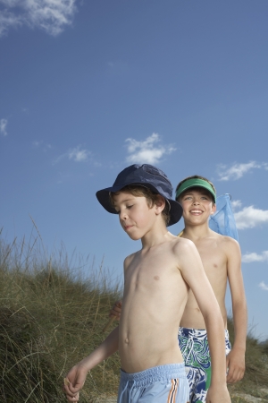 Two boys (6-11) walking in sand dunesの写真素材
