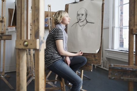 Thoughtful student by charcoal portrait in art schoolの写真素材