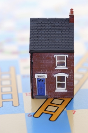 Plastic house on game boardの写真素材