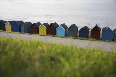Beach huts lined up along beach back viewの写真素材