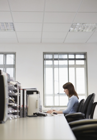 Woman working in office side viewの写真素材