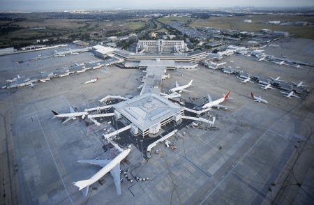 Man inspecting passenger jet undercarriageの写真素材