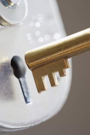 Golden key and padlock close-upの写真素材