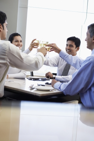 Business associates toasting with wine glassesの写真素材
