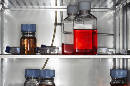 Bottles and containers on laboratory fridge shelf close upの写真素材