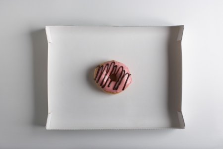 Single doughnut in cardbard boxの写真素材