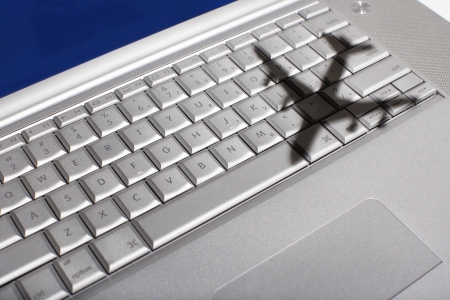 Shadow of jumbo jet over apple macintosh keyboardの写真素材