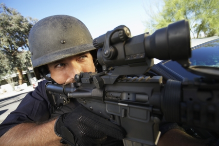 Portrait of Swat officer aiming gun