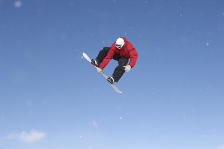 Teenage snowboarder jumpingの写真素材