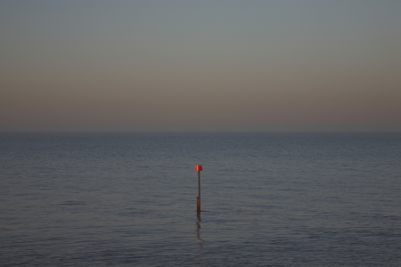 Beacon in ocean at duskの写真素材