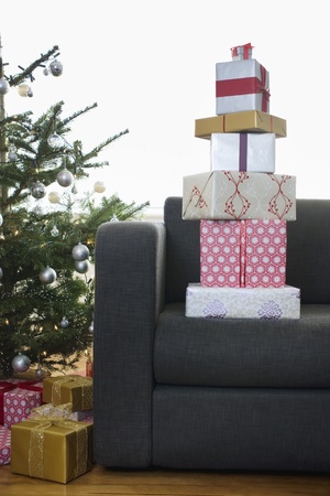 Stack of Christmas presents on armchairの写真素材