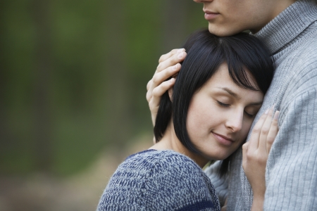 Young Woman Laying Head on Chest of Young Manの写真素材