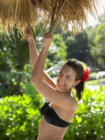 Young Woman in Bikini with Flower in Hairの写真素材