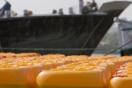 Dubai UAE Cooking oil waits to be loaded aboard a dhow headed for Iran or Somalia.の写真素材