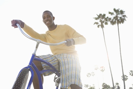 Man with bike on beachの写真素材