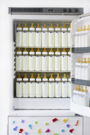 Fridge full of baby bottles with milkの写真素材