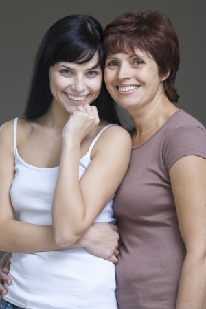 Studio portrait of young woman with motherの写真素材