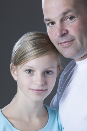 Studio portrait of father and daughter smilingの写真素材