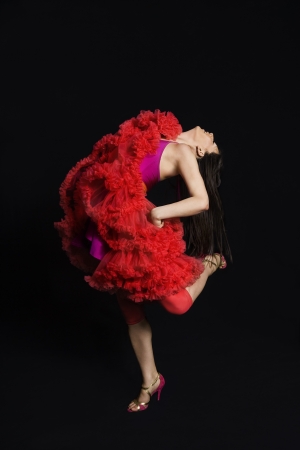 Woman dancing against black backgroundの写真素材