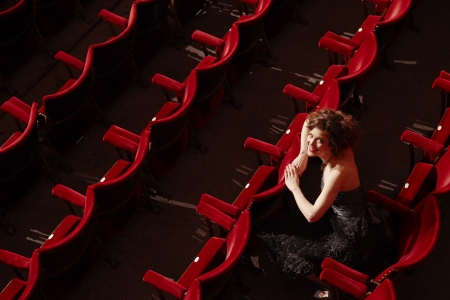 Woman sitting in theatre stalls high angle viewの写真素材