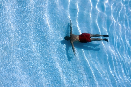 Man in swimming pool view from above