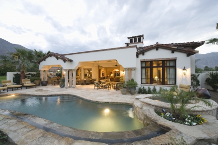 Poolside and lit interior of Palm Springs homeの写真素材