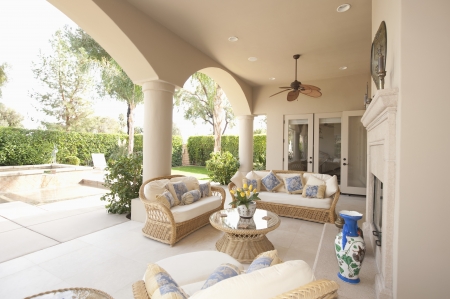 Neutral outdoor room with cane furniture