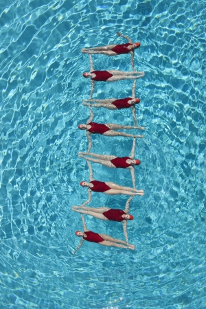 Synchronised swimmers form a ladderの写真素材