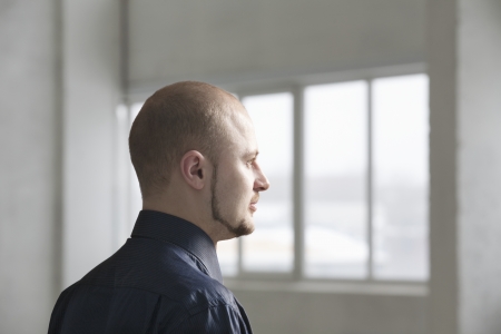 Profile of young businessman in warehouse interiorの写真素材