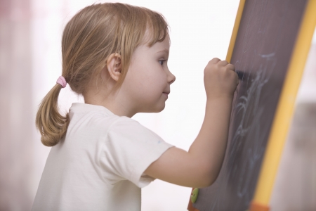 Young girl drawing on chalkboardの写真素材