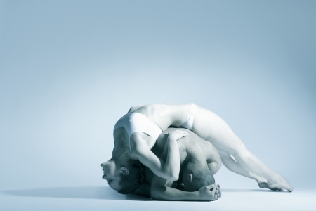Woman in underwear leans backwards over dance partnerの写真素材