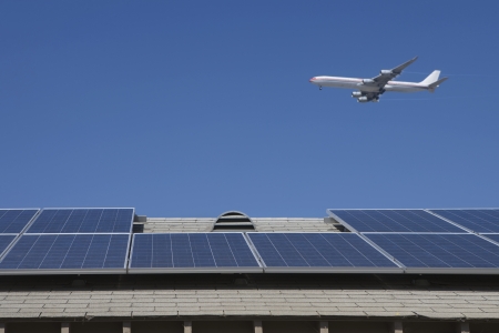 Aeroplane and rooftop with solar array Inglewood Los Angeles Californiaの写真素材