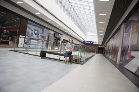 Young woman sits in new Voronezh shopping centreの写真素材