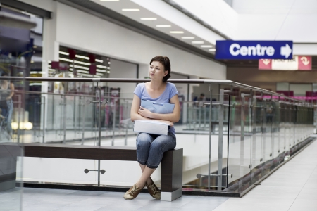Young woman sits in new Voronezh shopping centreの写真素材