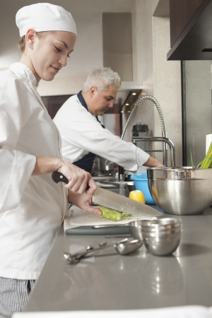 Young chef choppingの写真素材