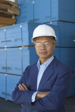 Portrait of manager wearing hard hat with arms crossedの写真素材
