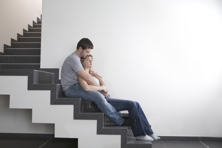 Young couple sit on staircase  copyspaceの写真素材