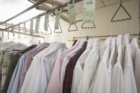 Clothes hanging in the laundretteの写真素材