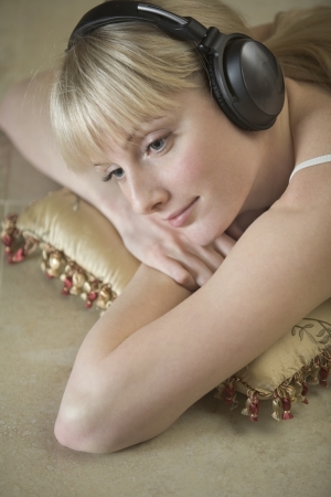 Portrait of a young woman relaxing with headdphones onの写真素材