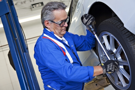 Car mechanic working on car tire