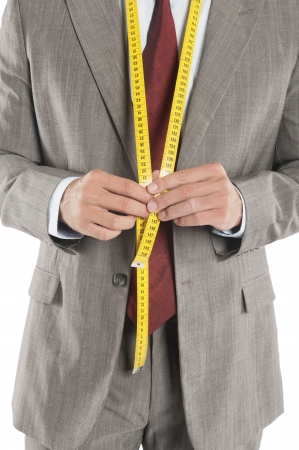 Man wearing a tape measure across his suitの写真素材