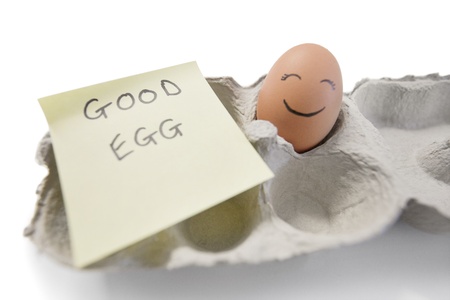 Happy egg with a note written 'good egg'の写真素材