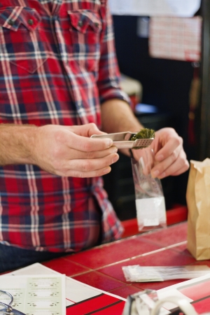 Midsection of man working in teahouseの写真素材