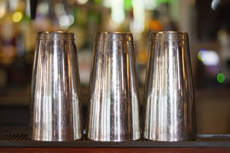 Close-up view of three steel glass kept upside down