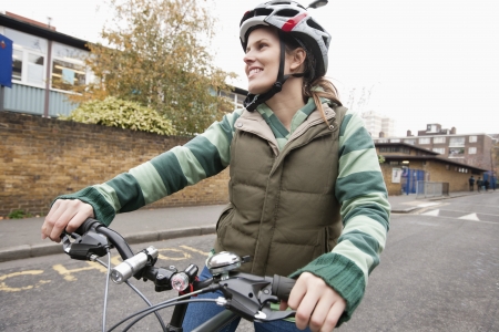 Young woman riding bicycle on streetの写真素材