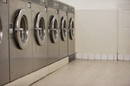 Row of self-service clothes dryers in Laundromatの写真素材