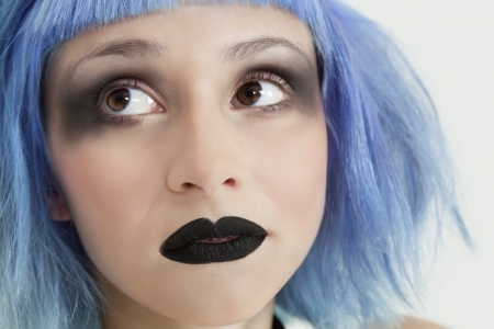 Close-up of young female punk with black lipstick,eye make-up and blue hairの写真素材
