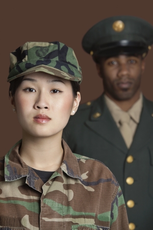 Portrait of young female US Marine Corps soldier with officer in the backgroundの写真素材